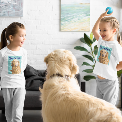 Two little girls wearing their custom Pink Poster dog art t-shirt playing with a golden retriever