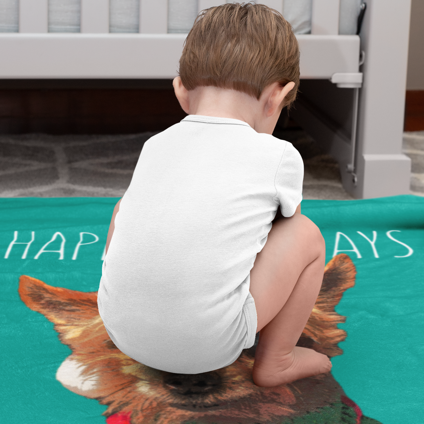 toddler sitting on his custom blanket