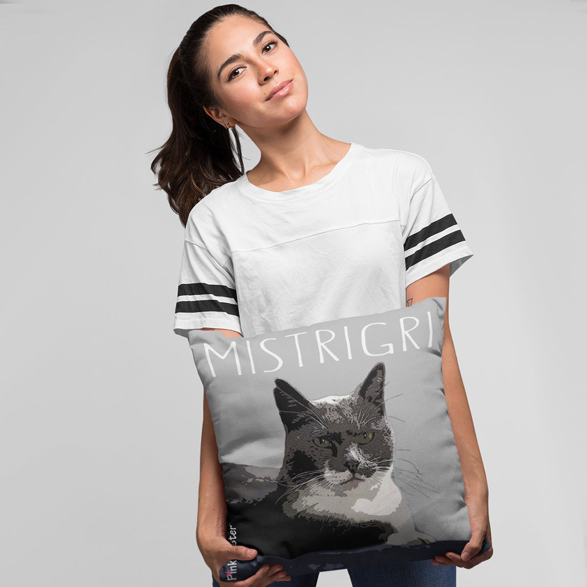 Young lady holding her PinkPoster pillow with her cat art on it